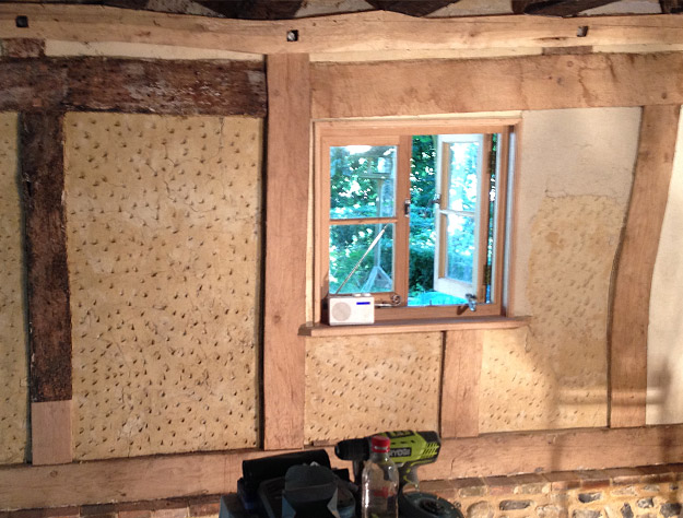 Plastering the panels with a lime mix